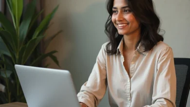 South Asian business owner managing a Netflix ad campaign on a laptop in a modern office setting